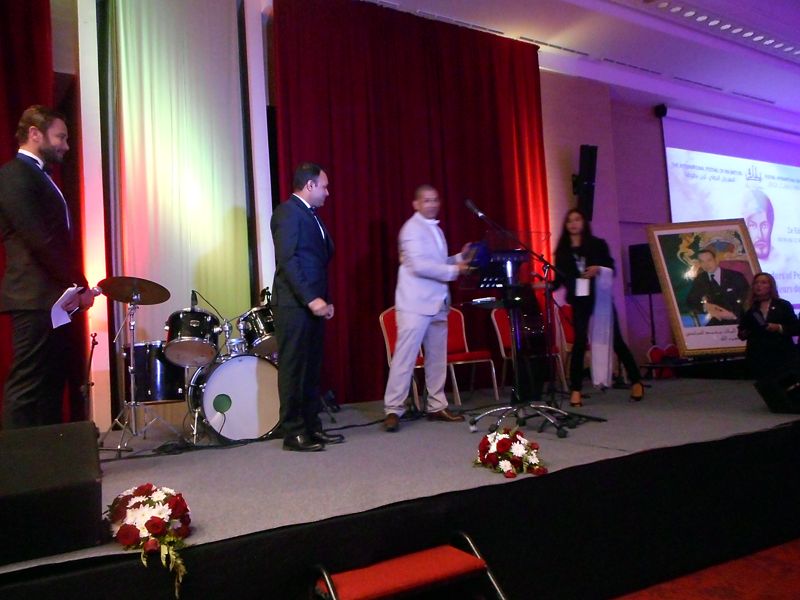 Receiving the Ambassador of Peace plaque on stage